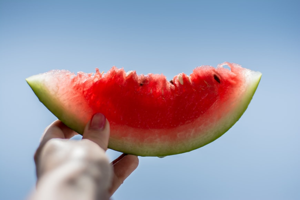 A partially eaten slice of watermelon